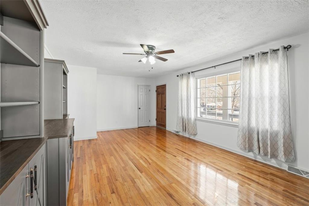 240 John Phillips Road Cedartown, GA 30125 - Photo 6 of 55 a view of empty room with wooden floor and fan