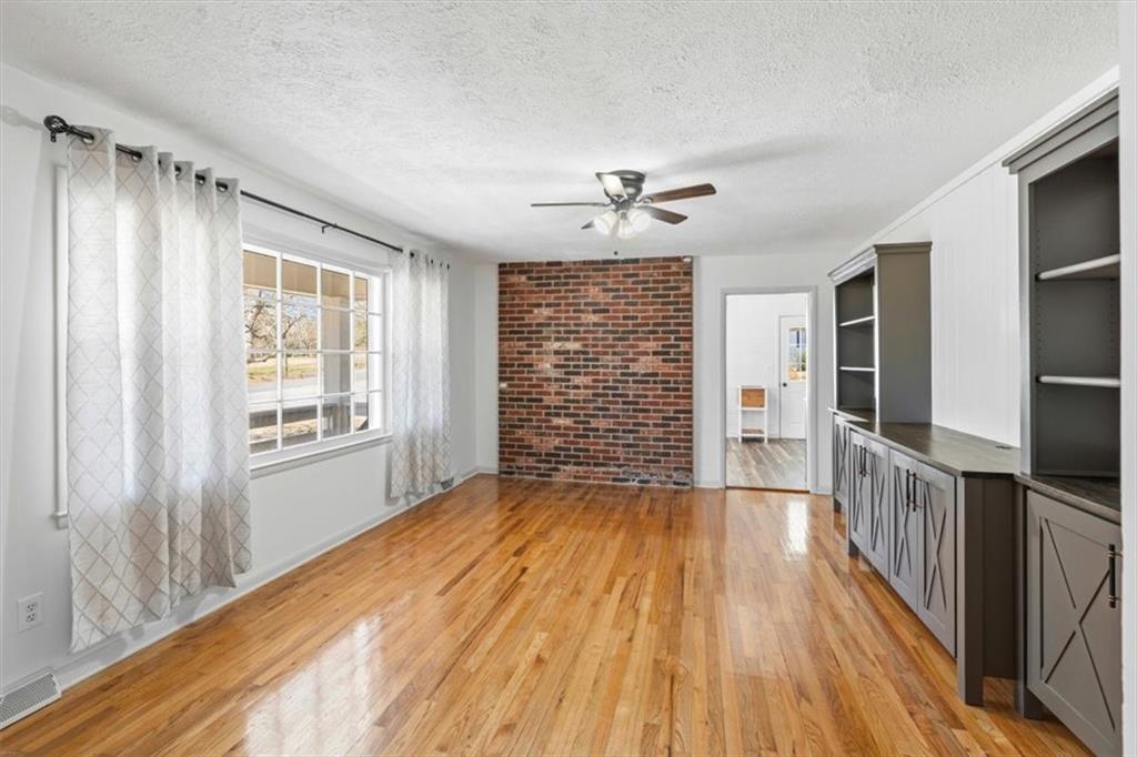 240 John Phillips Road Cedartown, GA 30125 - Photo 7 of 55 a view of empty room with wooden floor and fan