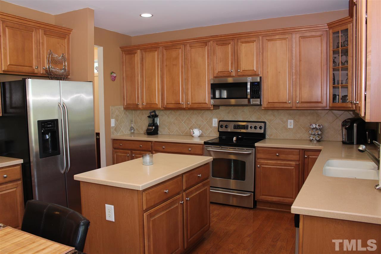 5125 Holly Ridge Farm Road Raleigh, NC 27616 - Photo 8 of 22 a kitchen with a sink stove and refrigerator