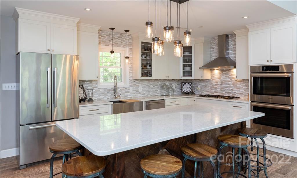1279 Lake Road Clover, SC 29710 - Photo 13 of 44 a kitchen with stainless steel appliances a dining table chairs and refrigerator