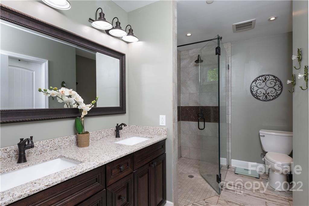 1279 Lake Road Clover, SC 29710 - Photo 17 of 44 a bathroom with a granite countertop sink a toilet and a mirror