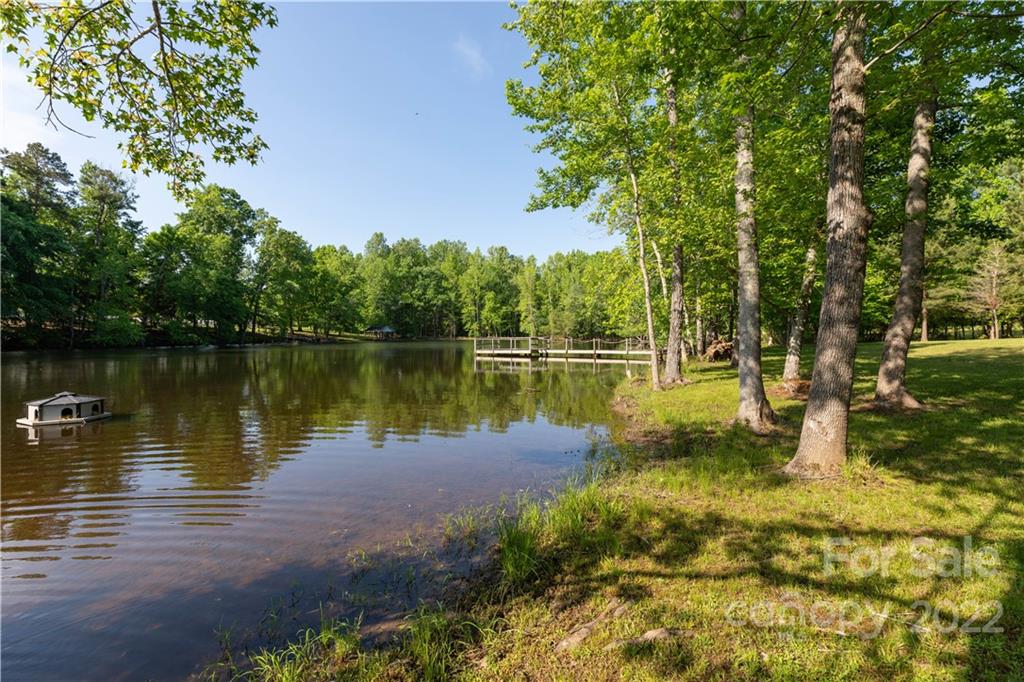 1279 Lake Road Clover, SC 29710 - Photo 32 of 44 a view of a lake with a garden and trees