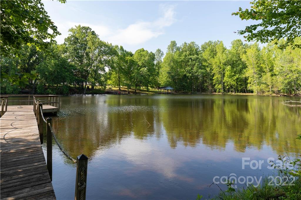 1279 Lake Road Clover, SC 29710 - Photo 36 of 44 a view of a lake with a house in the background