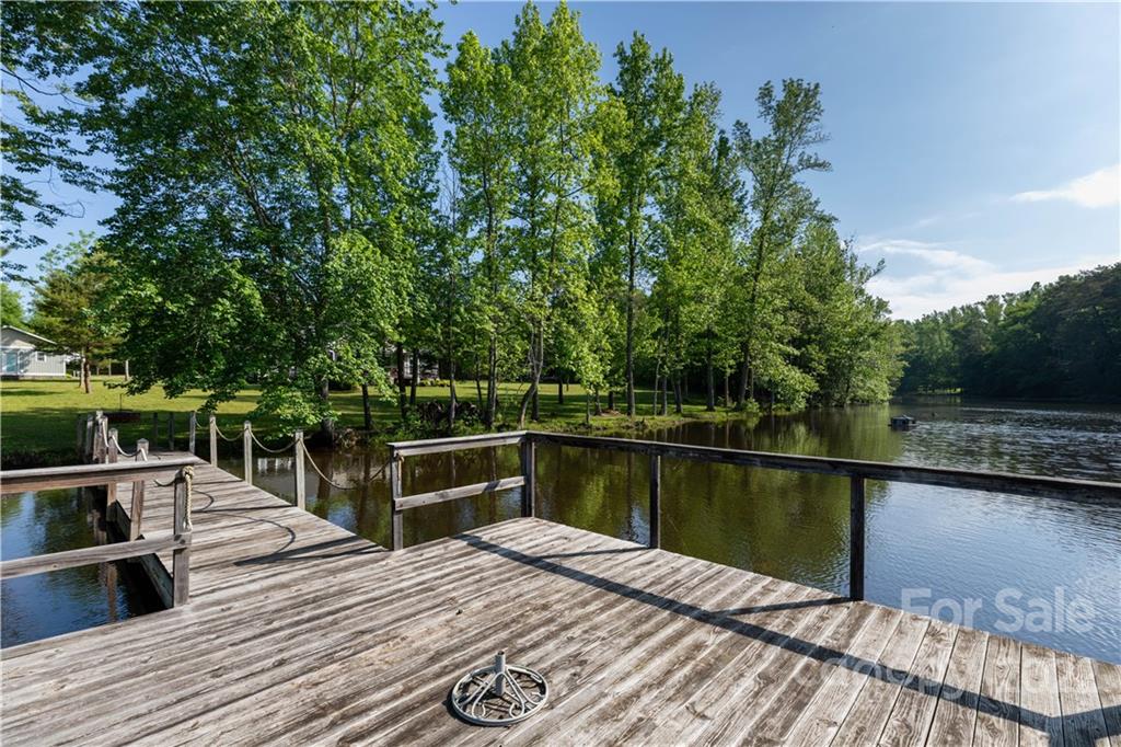 1279 Lake Road Clover, SC 29710 - Photo 38 of 44 a view of a wooden deck and lake with trees in the background