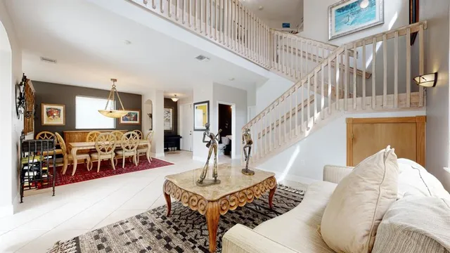 a living room with couches and a rug