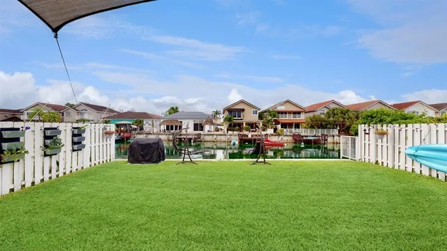 a view of a house with a yard and sitting area
