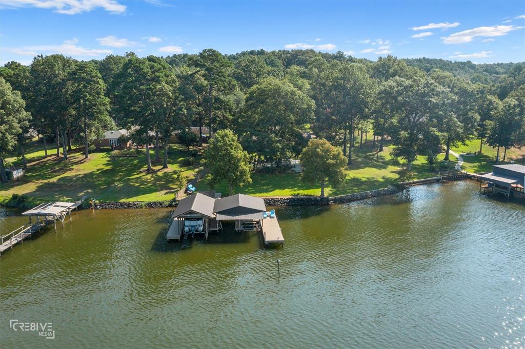 a view of a lake with lawn chairs