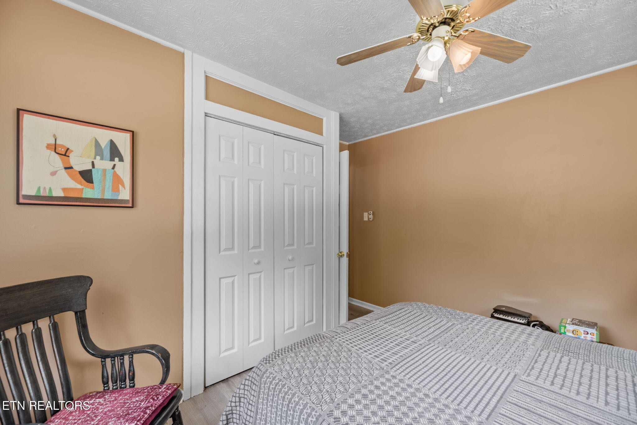 166 Outer Drive Oak Ridge, TN 37830 - Photo 19 of 30 a bedroom with a bed and wooden floor