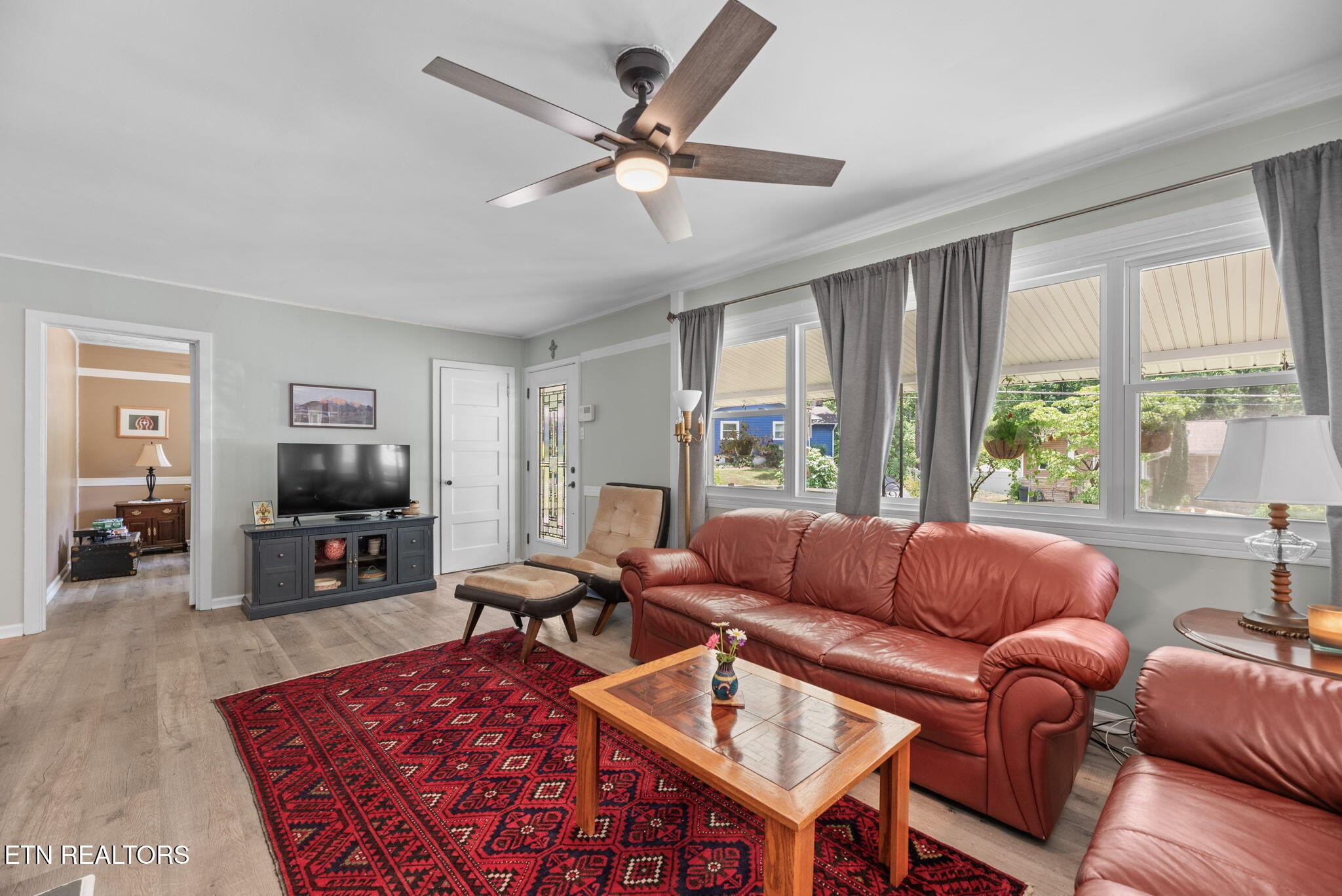 166 Outer Drive Oak Ridge, TN 37830 - Photo 8 of 30 a living room with furniture a large window and a flat screen tv