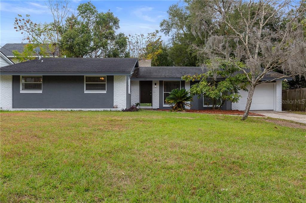 145 North Rhodes Street Mount Dora, FL 32757 - Photo 1 of 1 a front view of house with yard and trees in the background