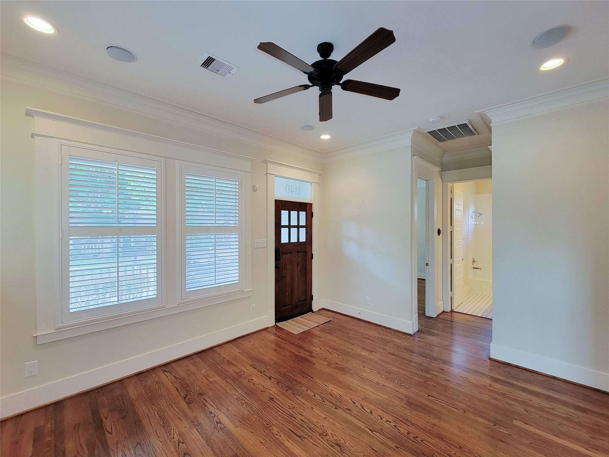 1140 West Cottage Street Houston, TX 77009 - Photo 6 of 37 a view of an empty room with wooden floor and a window