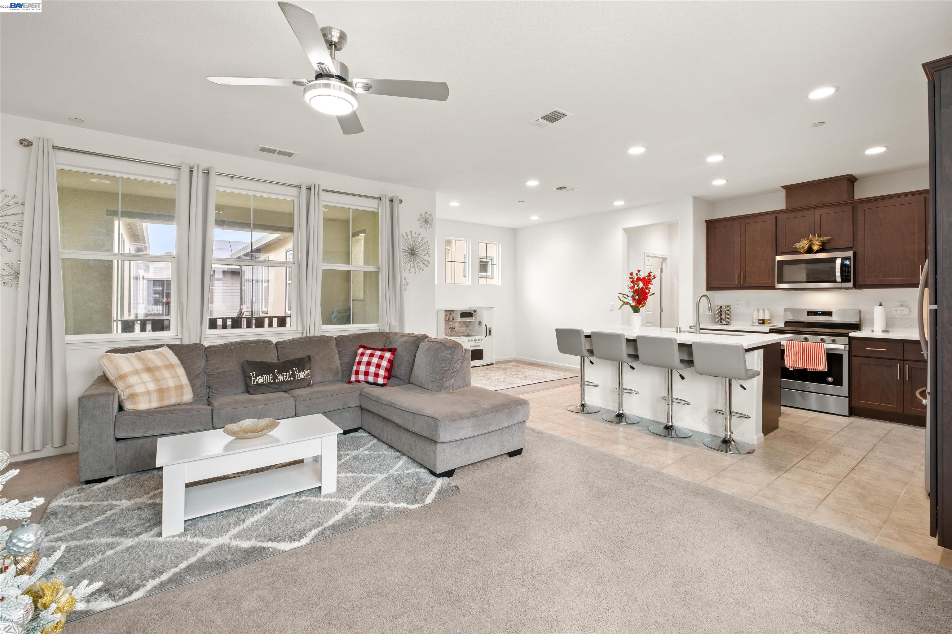 a living room with furniture and kitchen view
