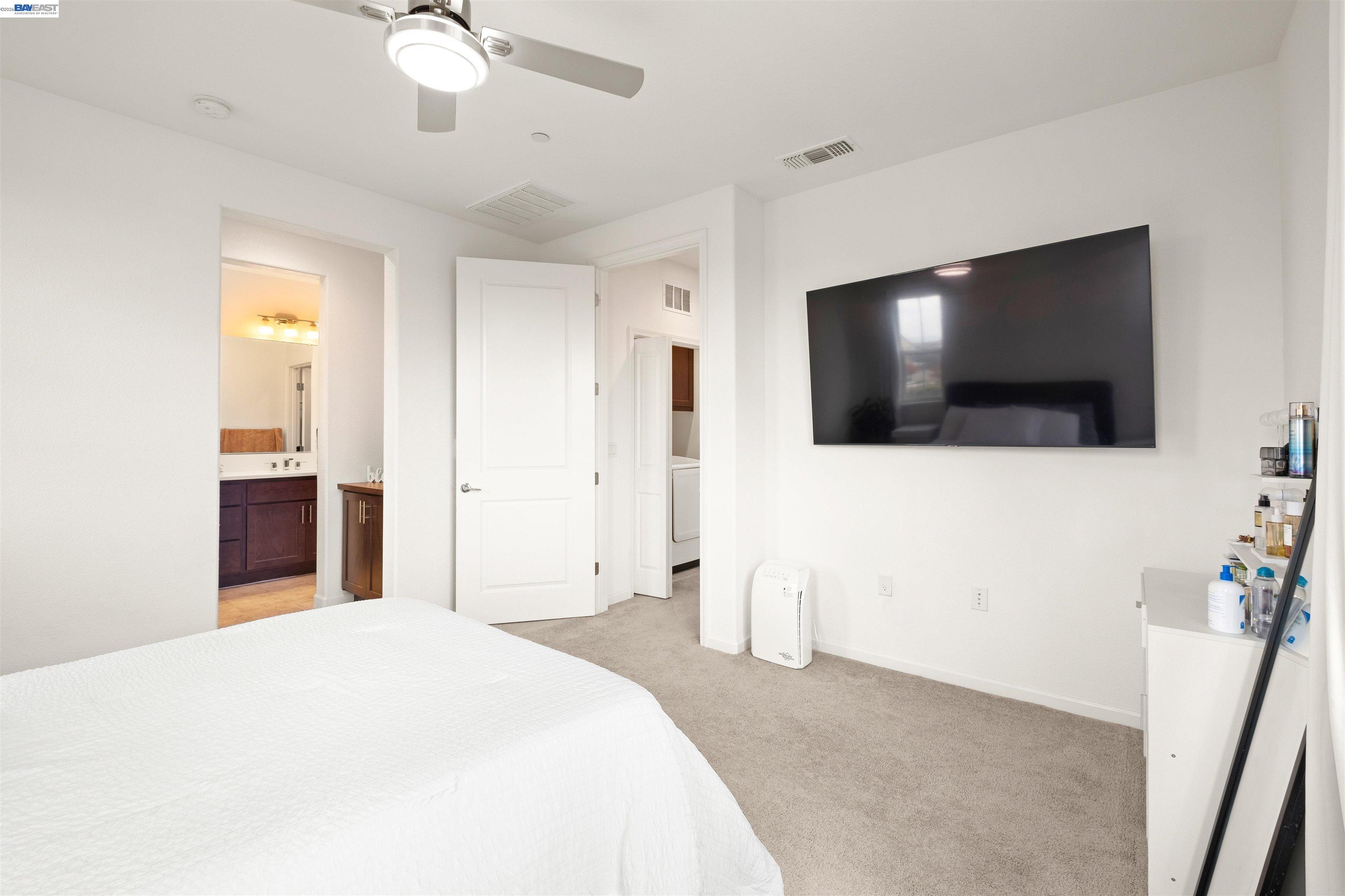 17575 Altair Way Lathrop, CA 95330 - Photo 11 of 29 a bedroom with a bed and a flat screen tv