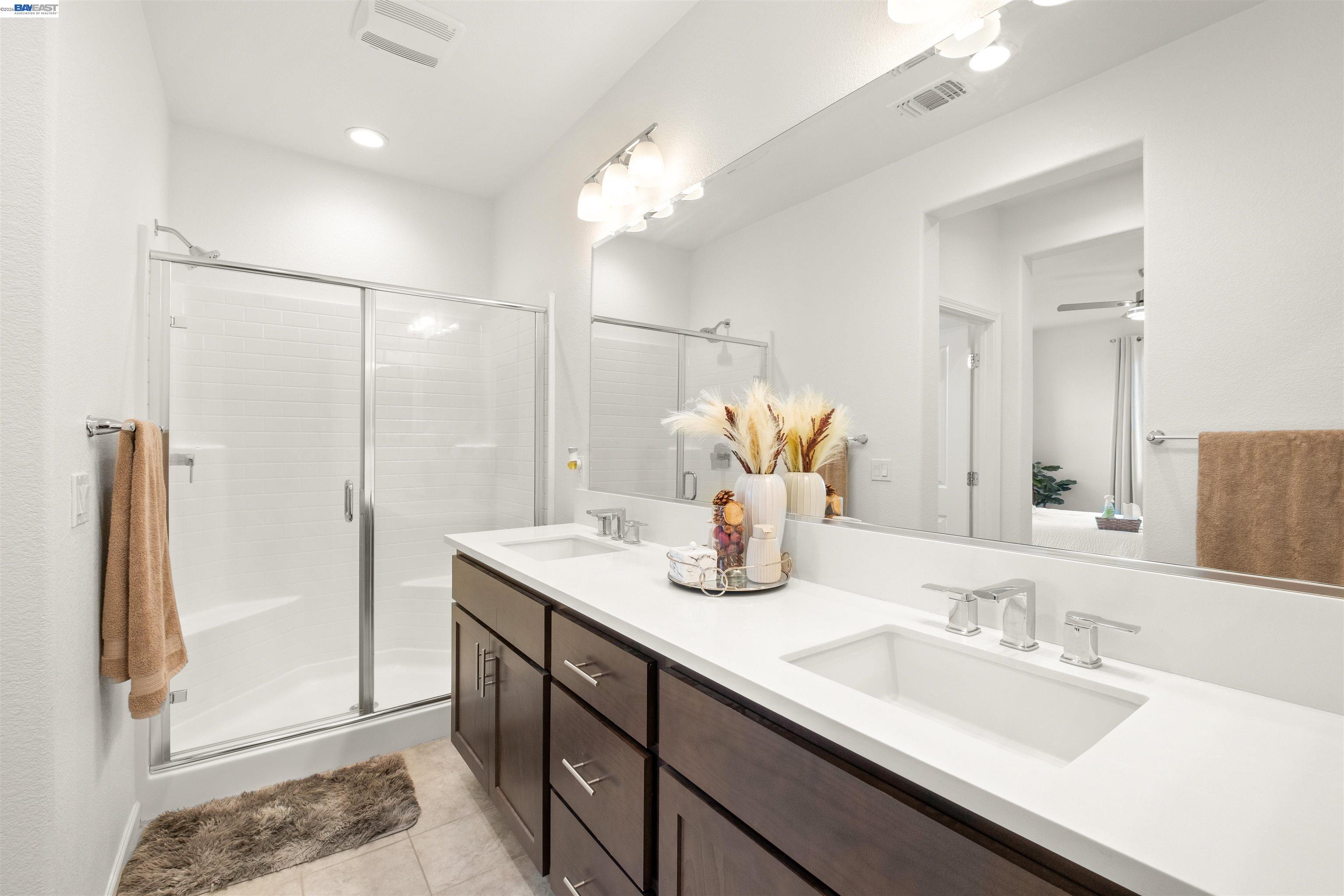 17575 Altair Way Lathrop, CA 95330 - Photo 13 of 29 a bathroom with a granite countertop sink and a mirror