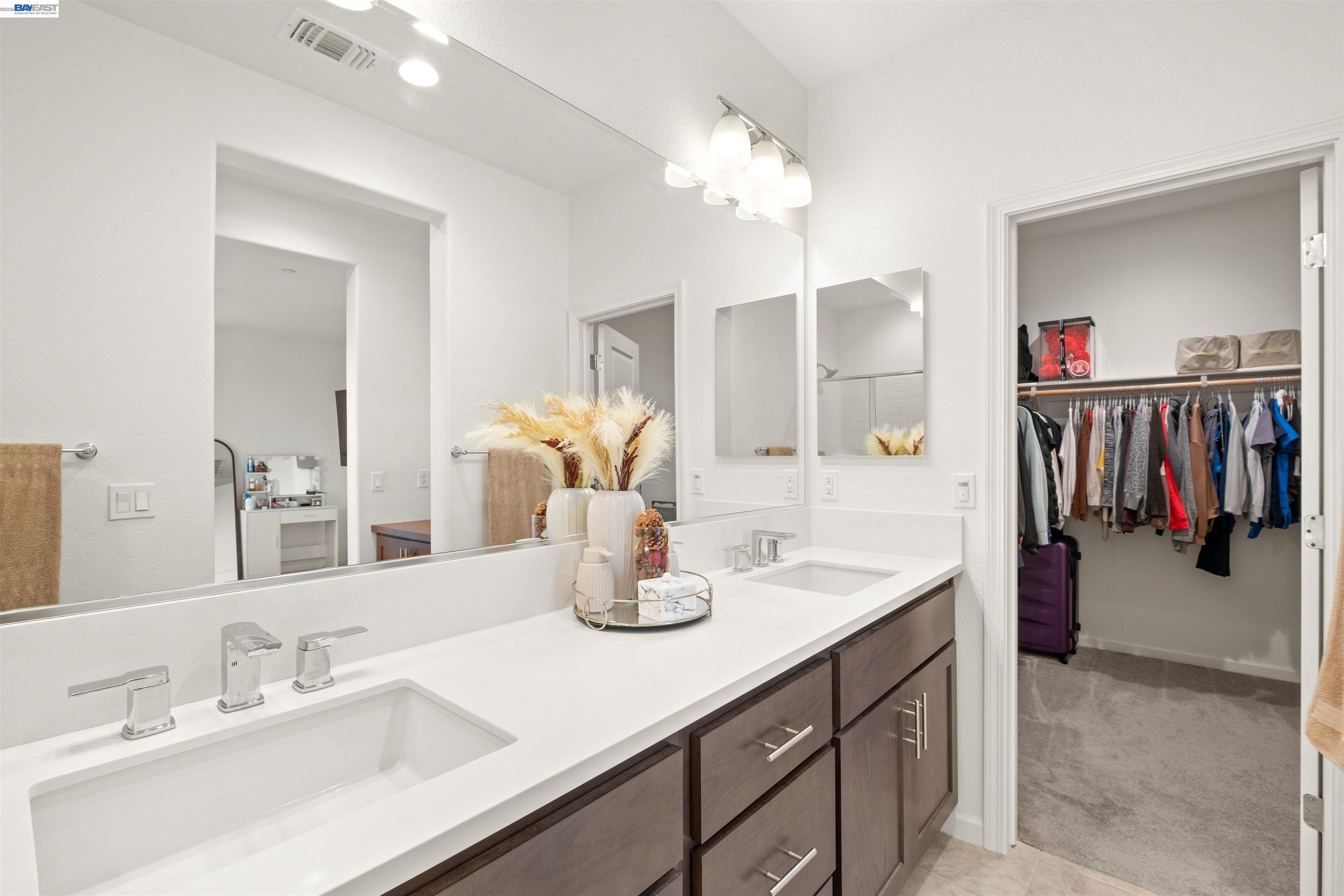 17575 Altair Way Lathrop, CA 95330 - Photo 14 of 29 a bathroom with a sink double vanity and a mirror