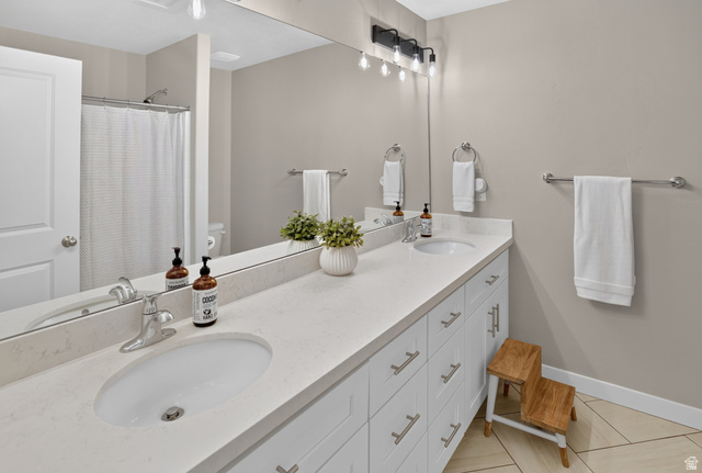 2178 Autumn Drive Mapleton, UT 84664 - Photo 23 of 48 Dual vanity with under-mount sinks, light-toned countertop, and white shaker-style cabinetry