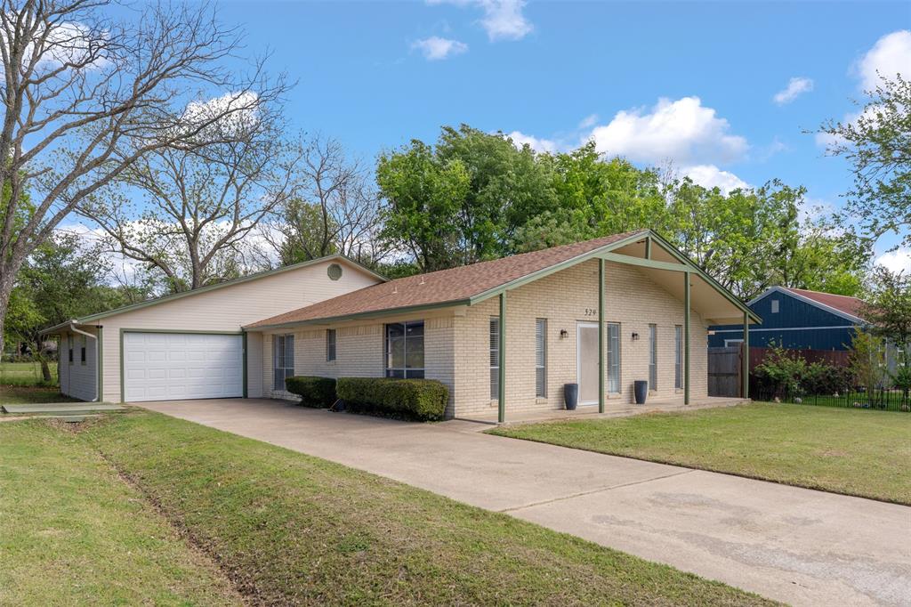 529 East Kempner Street Mabank, TX 75147 - Photo 1 of 16 a view of house with a yard and potted plants