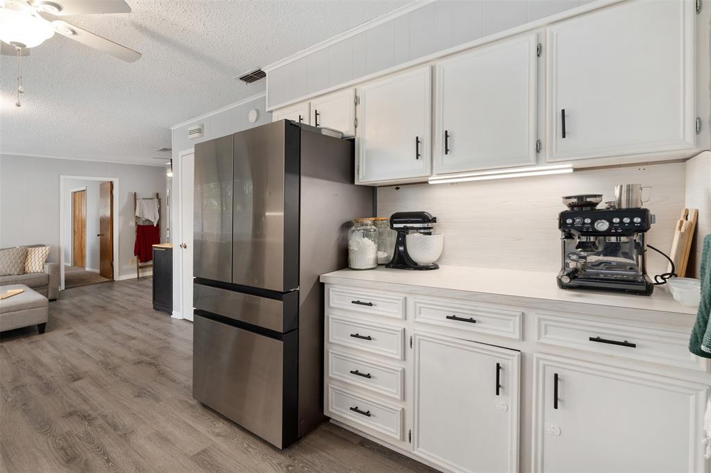 529 East Kempner Street Mabank, TX 75147 - Photo 5 of 16 a kitchen with stainless steel appliances a refrigerator sink and cabinets