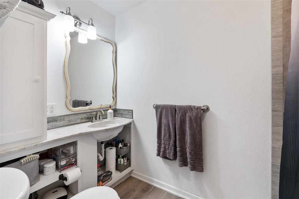 529 East Kempner Street Mabank, TX 75147 - Photo 8 of 16 a bathroom with a sink a mirror and vanity