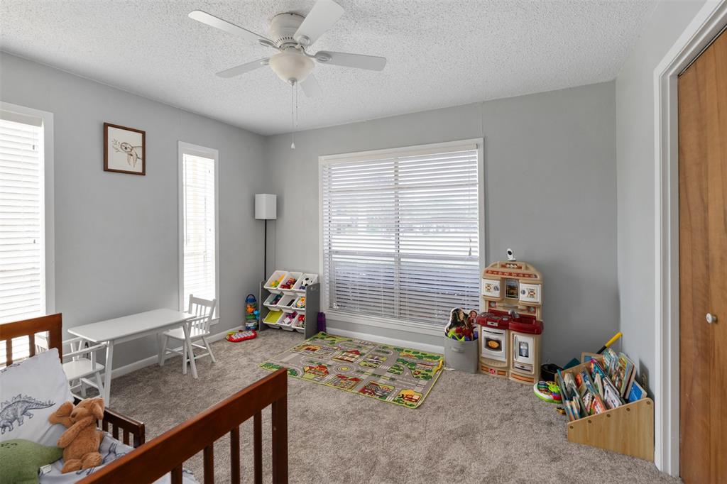 529 East Kempner Street Mabank, TX 75147 - Photo 10 of 16 a bedroom with furniture and a window