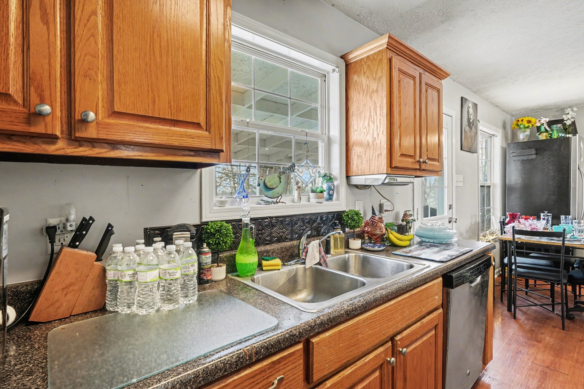 2490 Monte Murrey Road Lewisburg, TN 37091 - Photo 13 of 30 a kitchen with stainless steel appliances granite countertop a sink dishwasher and cabinets with wooden floor