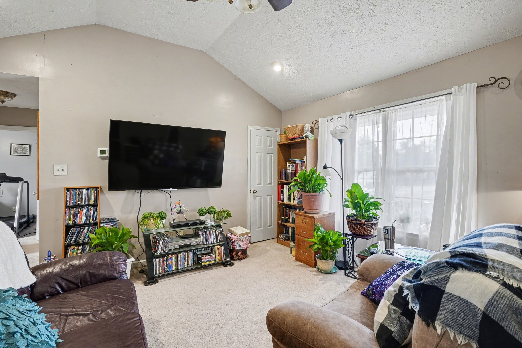 2490 Monte Murrey Road Lewisburg, TN 37091 - Photo 6 of 30 a living room with furniture a flat screen tv and a potted plant