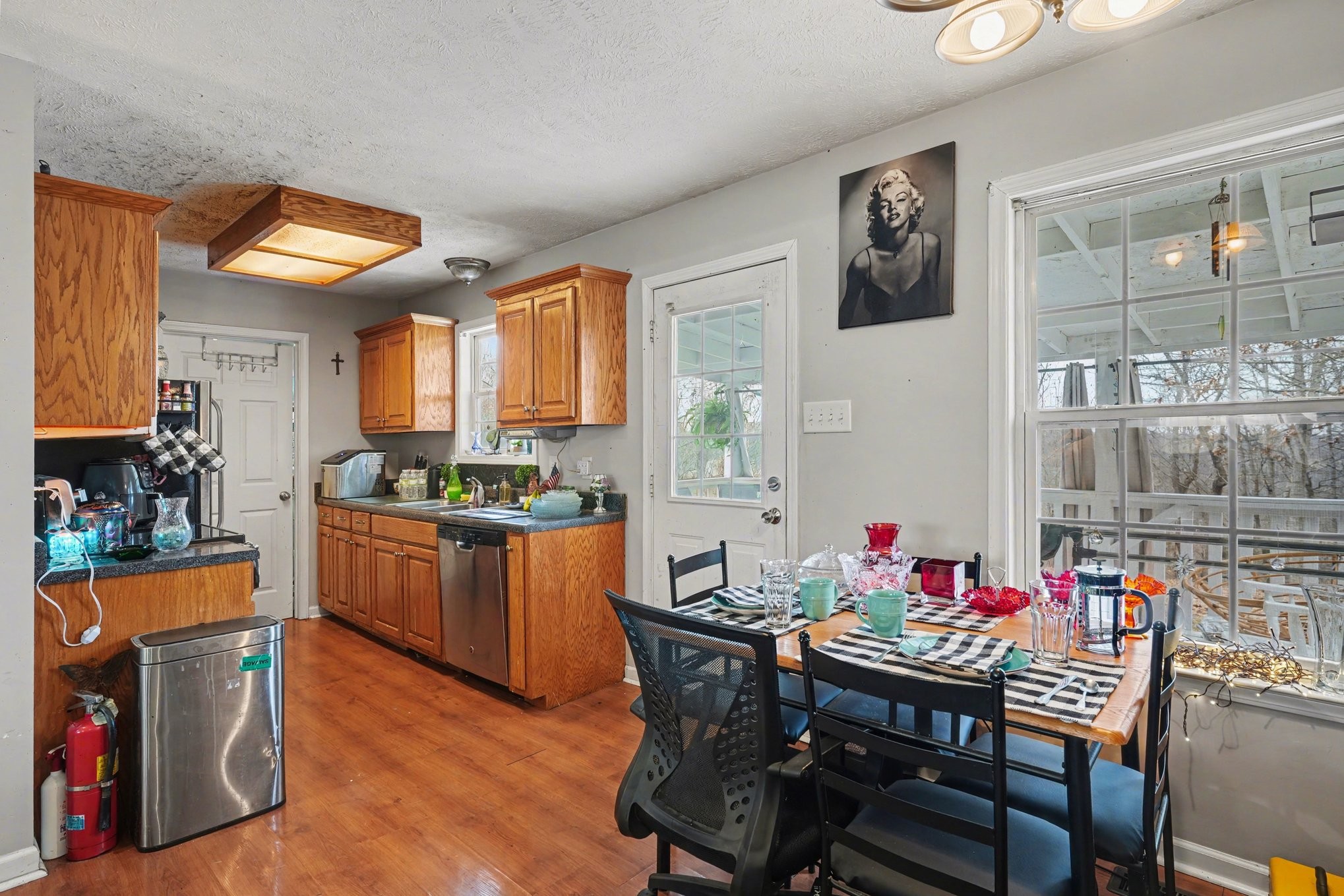 2490 Monte Murrey Road Lewisburg, TN 37091 - Photo 9 of 30 a kitchen with stainless steel appliances kitchen island granite countertop a dining table chairs and a refrigerator