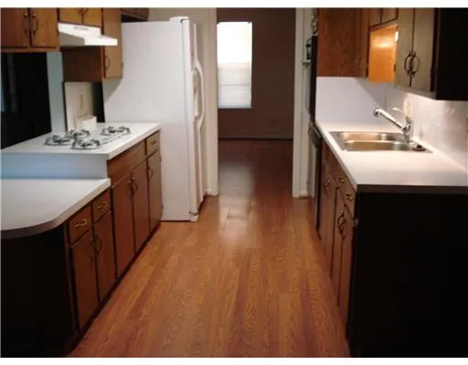 a kitchen with kitchen island sink stove and refrigerator