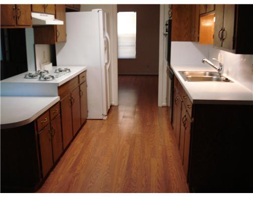212 Wilshire Street Portland, TX 78374 - Photo 3 of 9 a kitchen with kitchen island sink stove and refrigerator