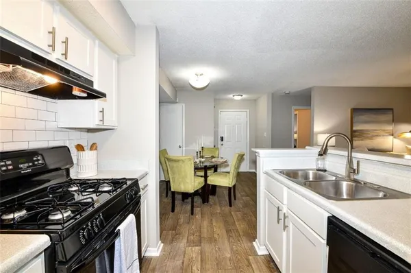 a kitchen with a sink appliances and cabinets