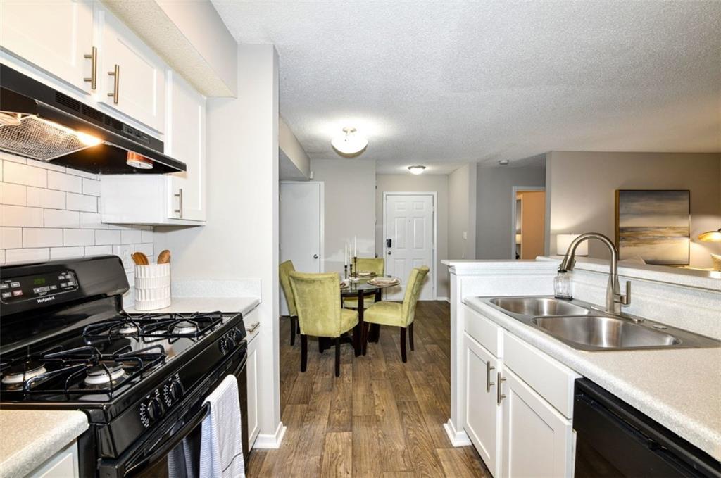 670 Thornton Road, Unit 1006 Lithia Springs, GA 30122 - Photo 1 of 26 a kitchen with a sink appliances and cabinets