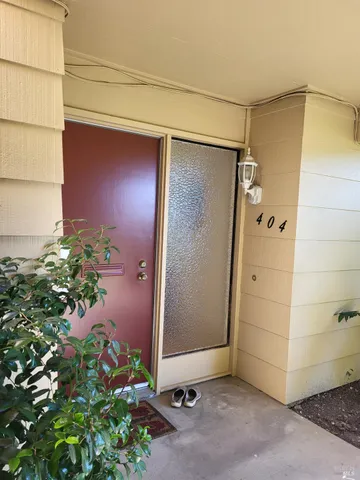 a living room with furniture a fireplace and a floor to ceiling window