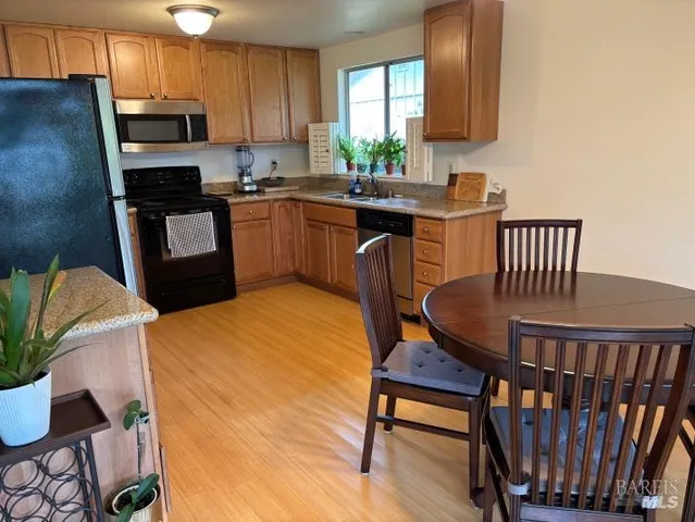 a bedroom with a bed and a flat tv screen on a dresser