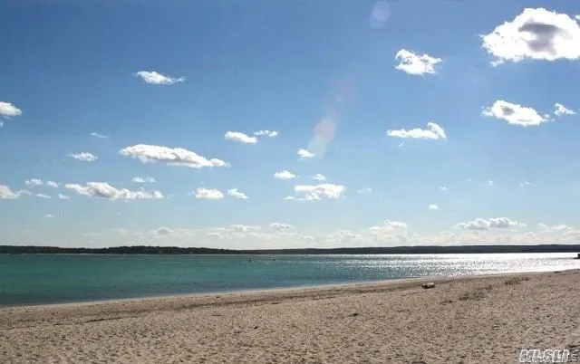 a view of a big room with a house and a lake view