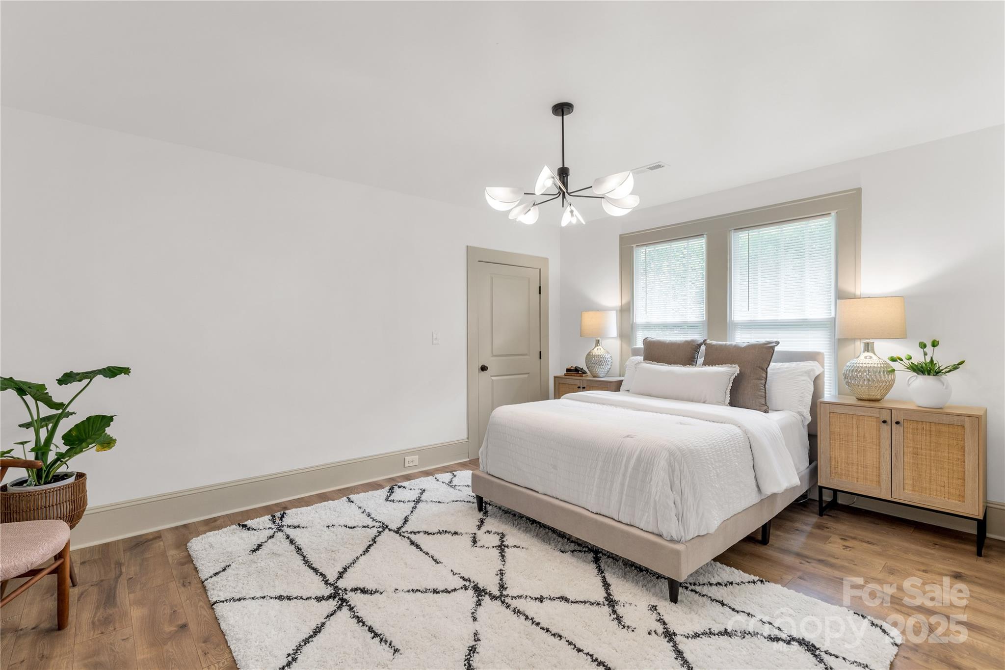 310 Elm Street Lancaster, SC 29720 - Photo 12 of 48 a bedroom with a large bed and chandelier