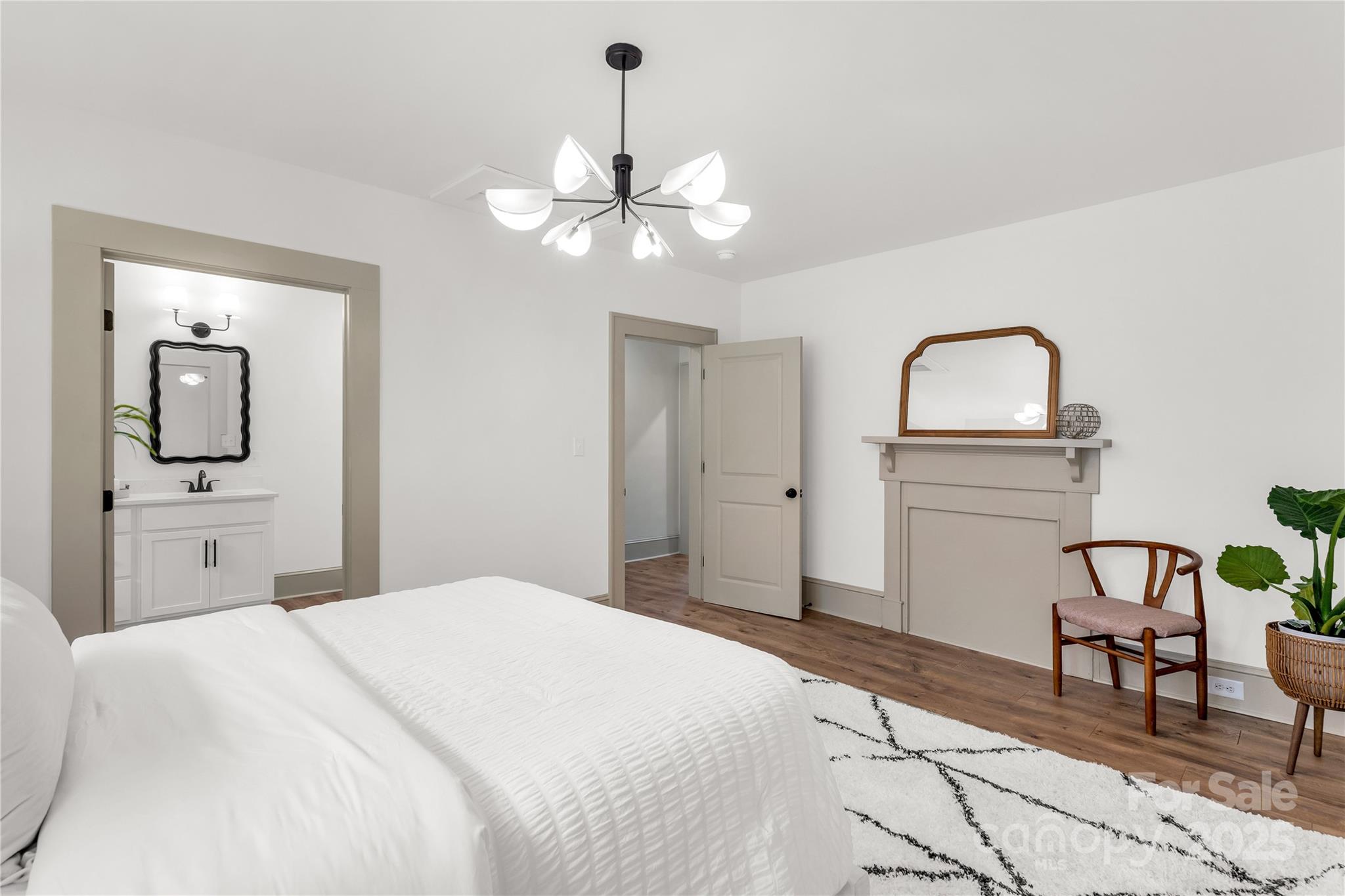 310 Elm Street Lancaster, SC 29720 - Photo 13 of 48 a bedroom with a bed and a chandelier