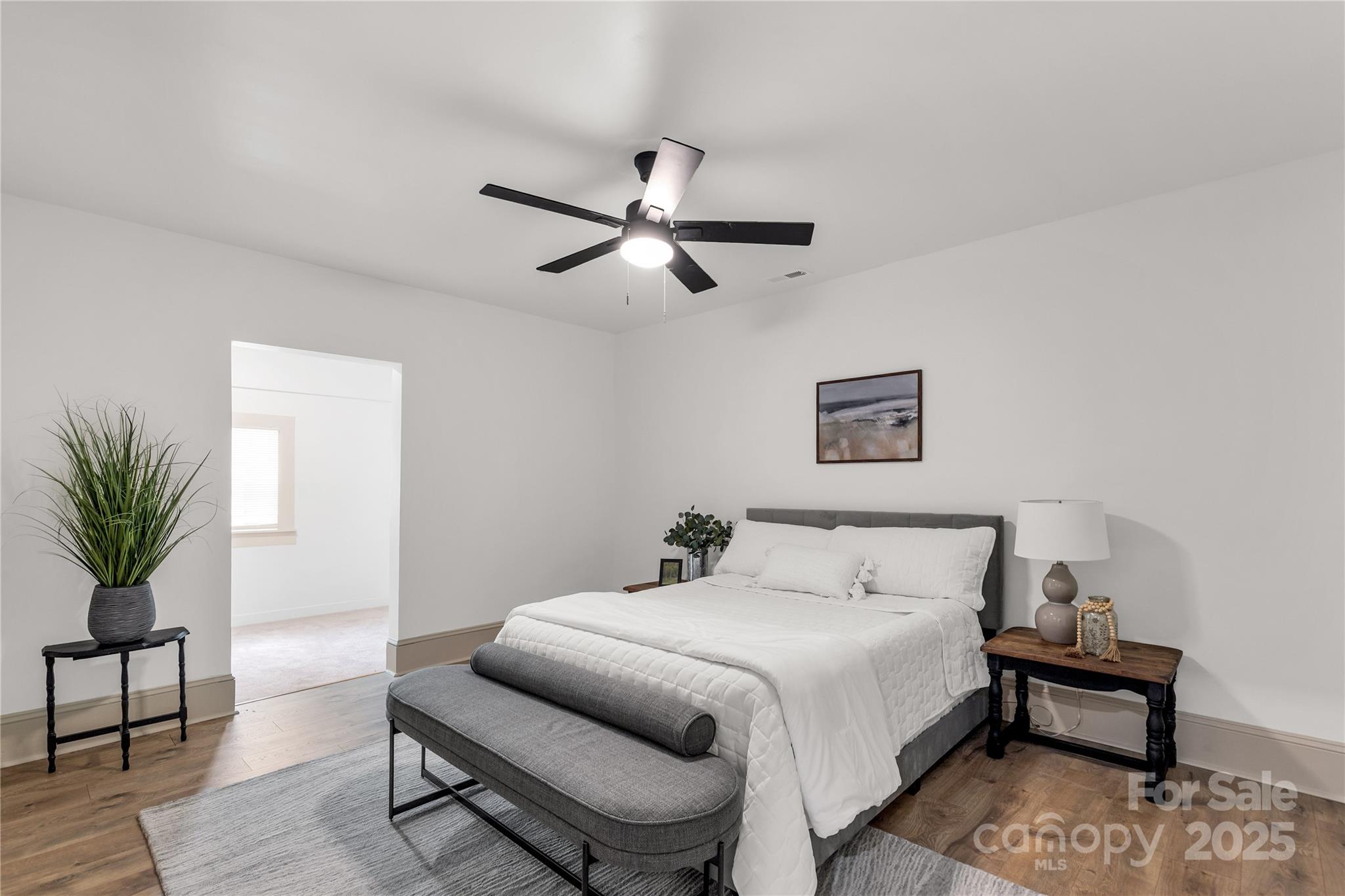 310 Elm Street Lancaster, SC 29720 - Photo 15 of 48 a bedroom with a bed and a potted plant