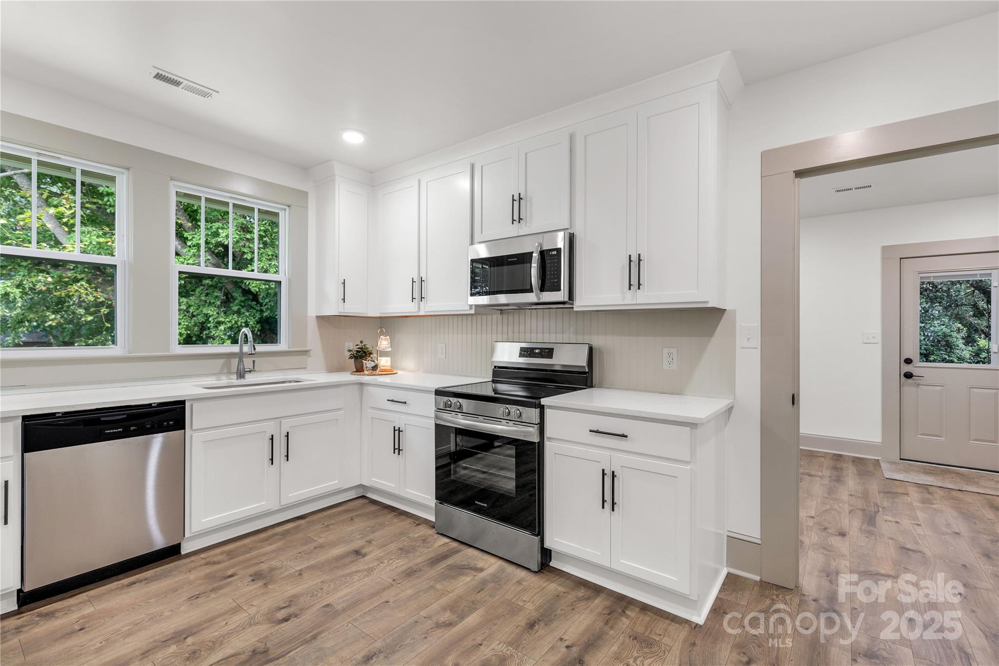 310 Elm Street Lancaster, SC 29720 - Photo 17 of 48 a kitchen with a stove a sink and a microwave