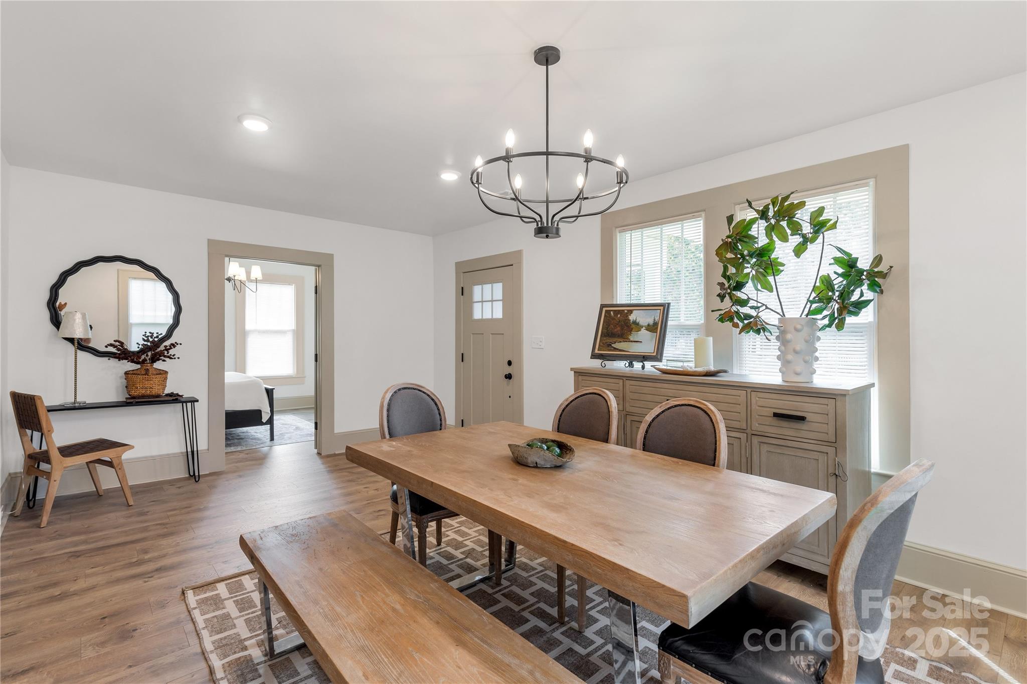 310 Elm Street Lancaster, SC 29720 - Photo 2 of 48 a view of a dining room with furniture a chandelier and wooden floor