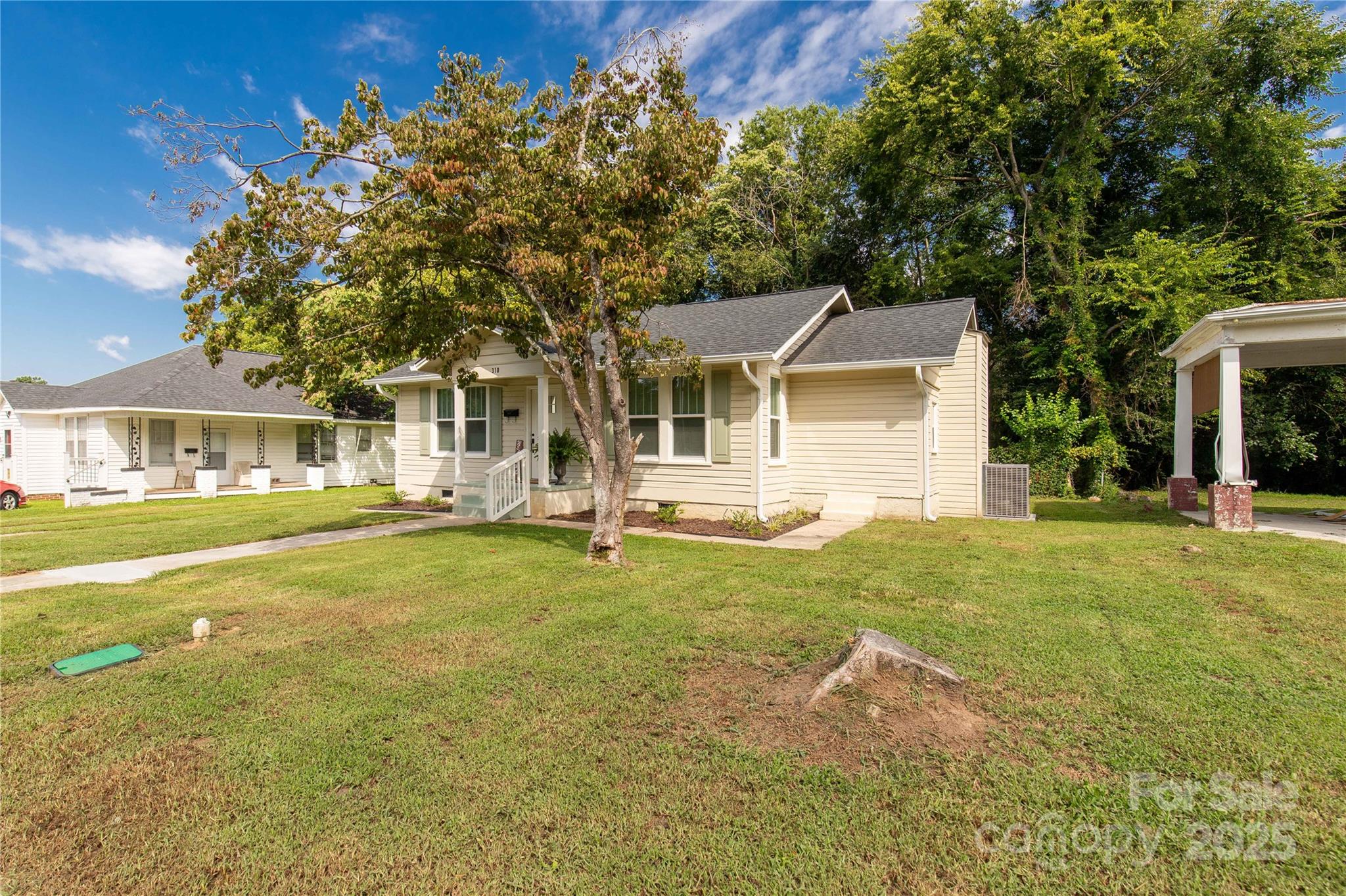 310 Elm Street Lancaster, SC 29720 - Photo 24 of 48 a front view of a house with a garden