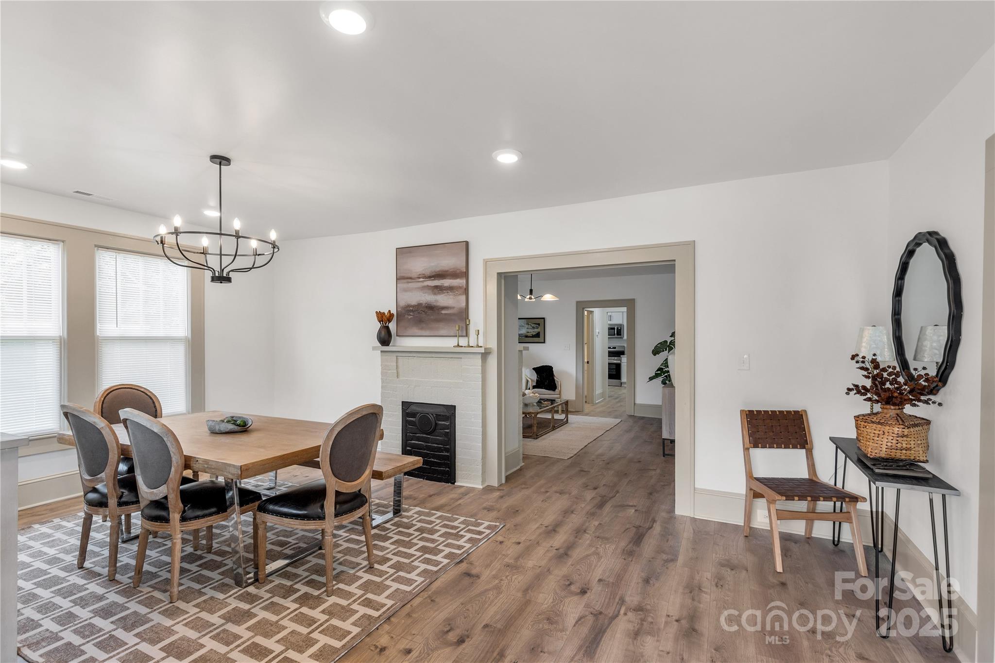 310 Elm Street Lancaster, SC 29720 - Photo 4 of 48 a view of a dining room with furniture a chandelier and wooden floor