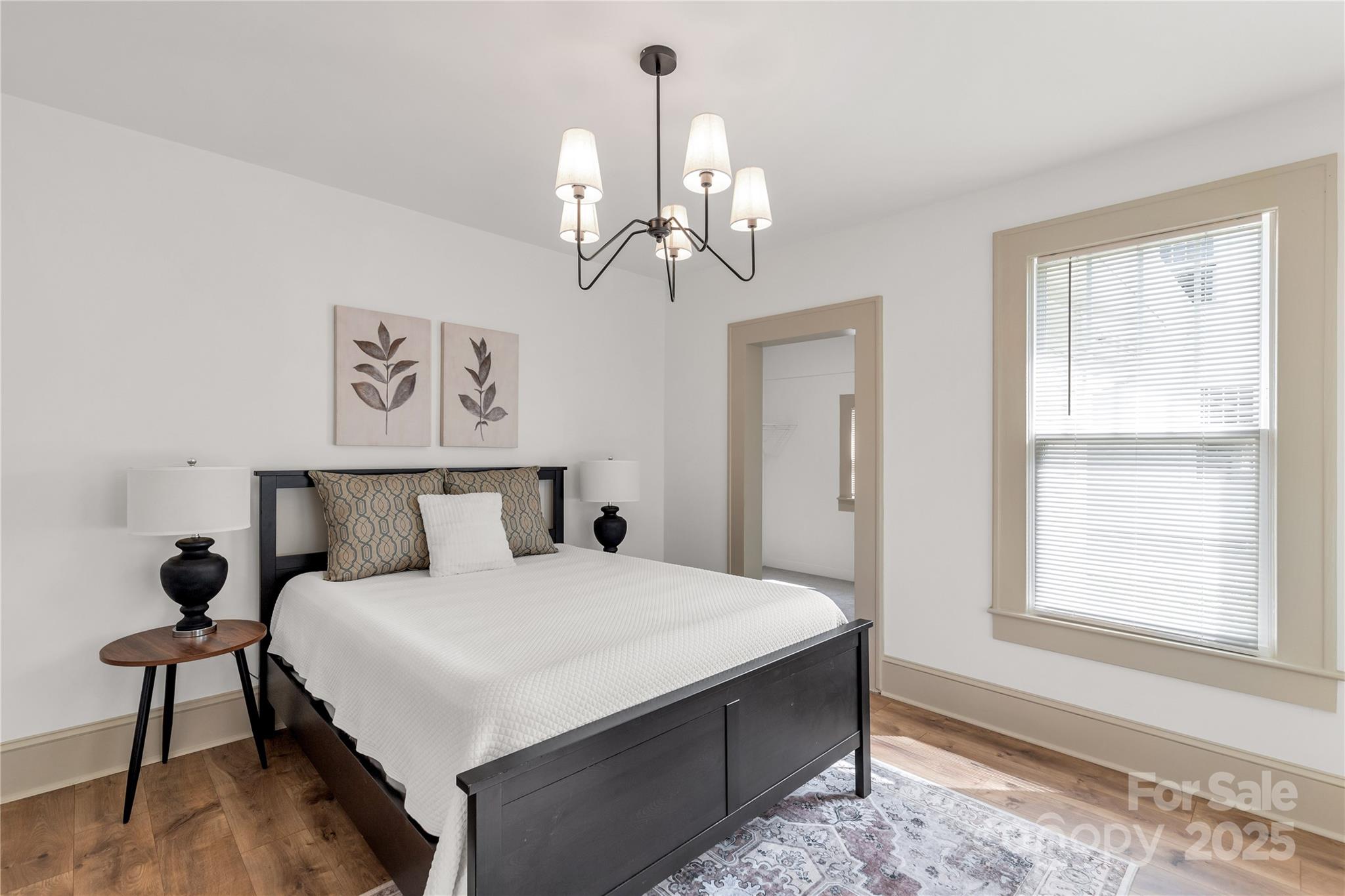 310 Elm Street Lancaster, SC 29720 - Photo 5 of 48 a bedroom with a bed and a chandelier