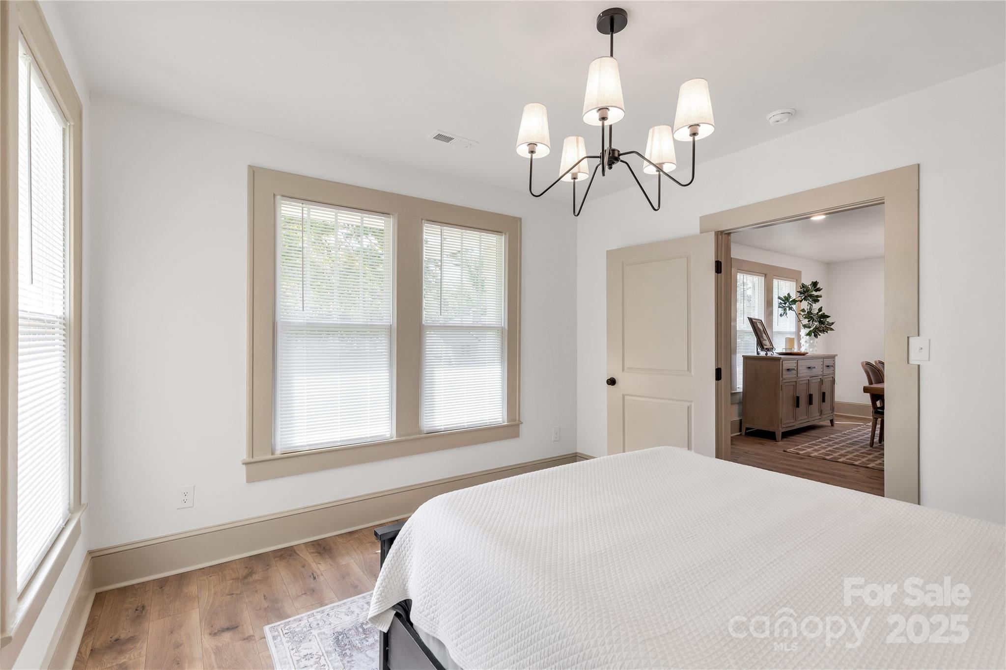 310 Elm Street Lancaster, SC 29720 - Photo 6 of 48 a bedroom with a bed and a chandelier