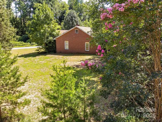 a view of a house with a yard and garden