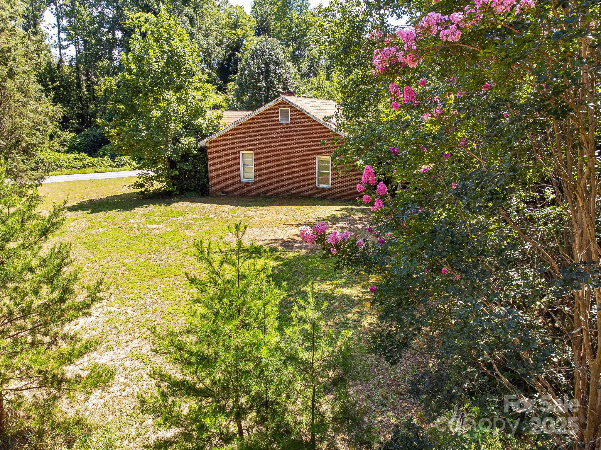 211 Luckadoo Road Bostic, NC 28018 - Photo 11 of 32 a view of a house with a yard and garden