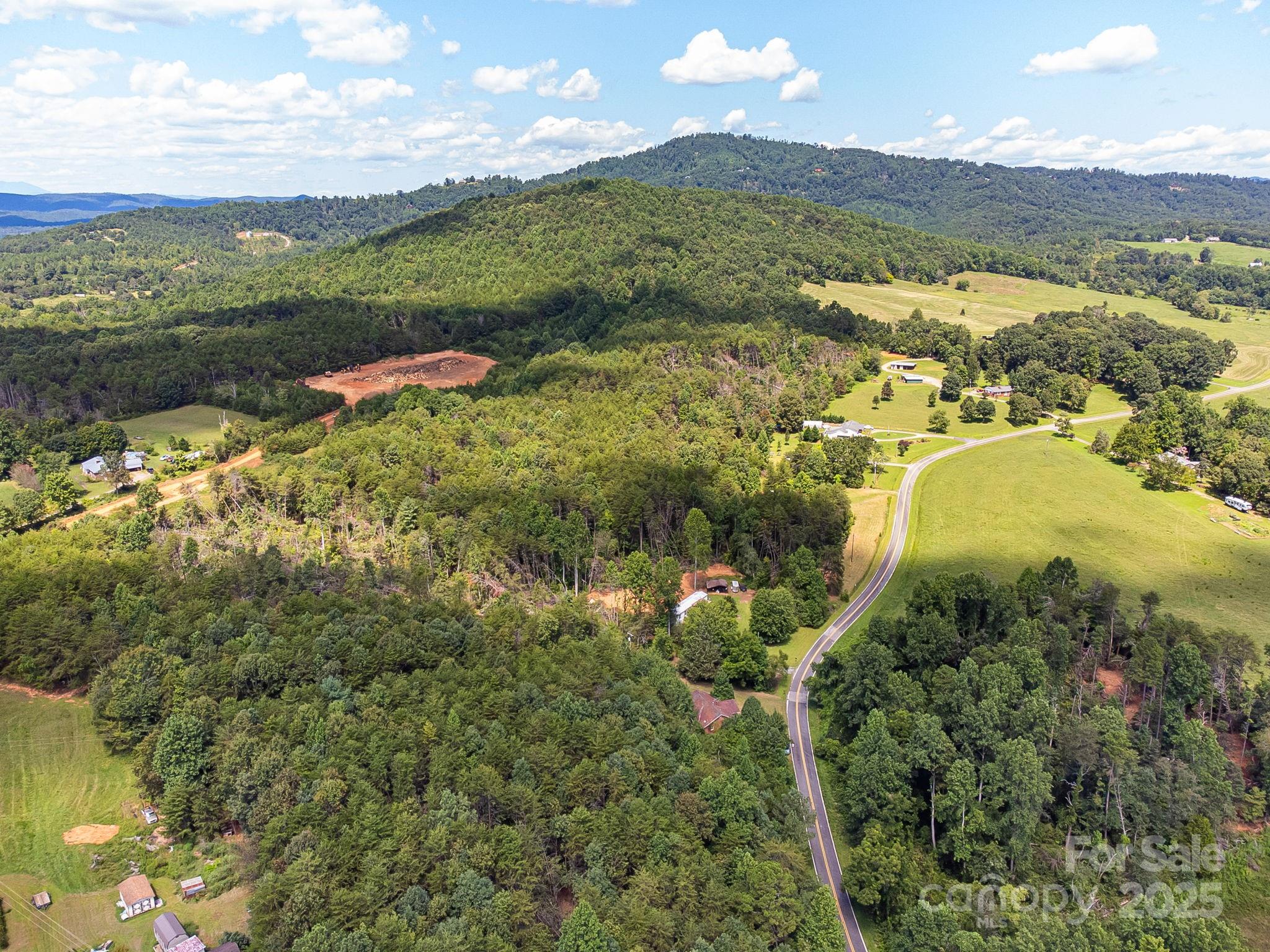 211 Luckadoo Road Bostic, NC 28018 - Photo 19 of 32 a view of a lake with a mountain