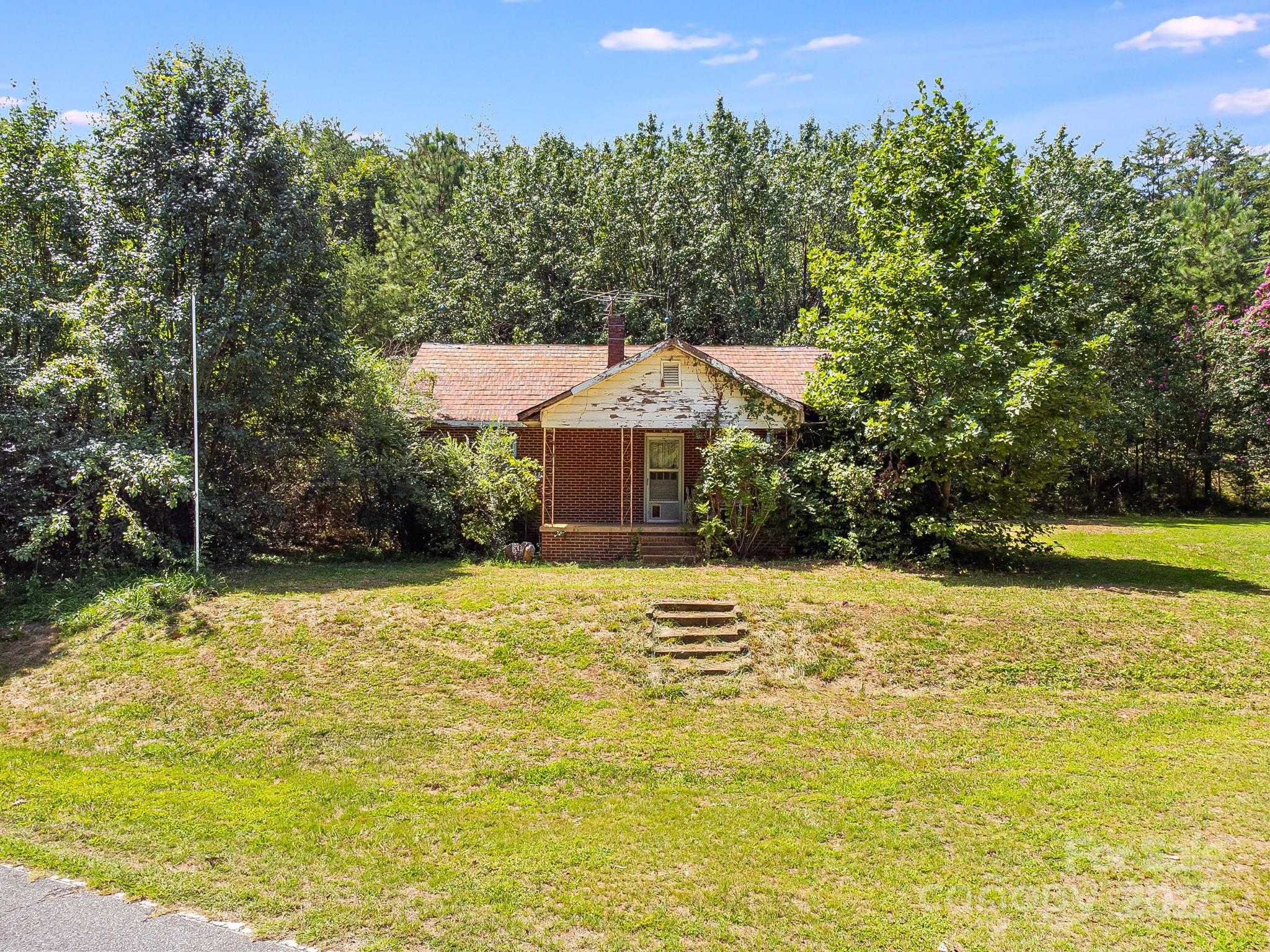211 Luckadoo Road Bostic, NC 28018 - Photo 23 of 32 a front view of a house with a yard and trees