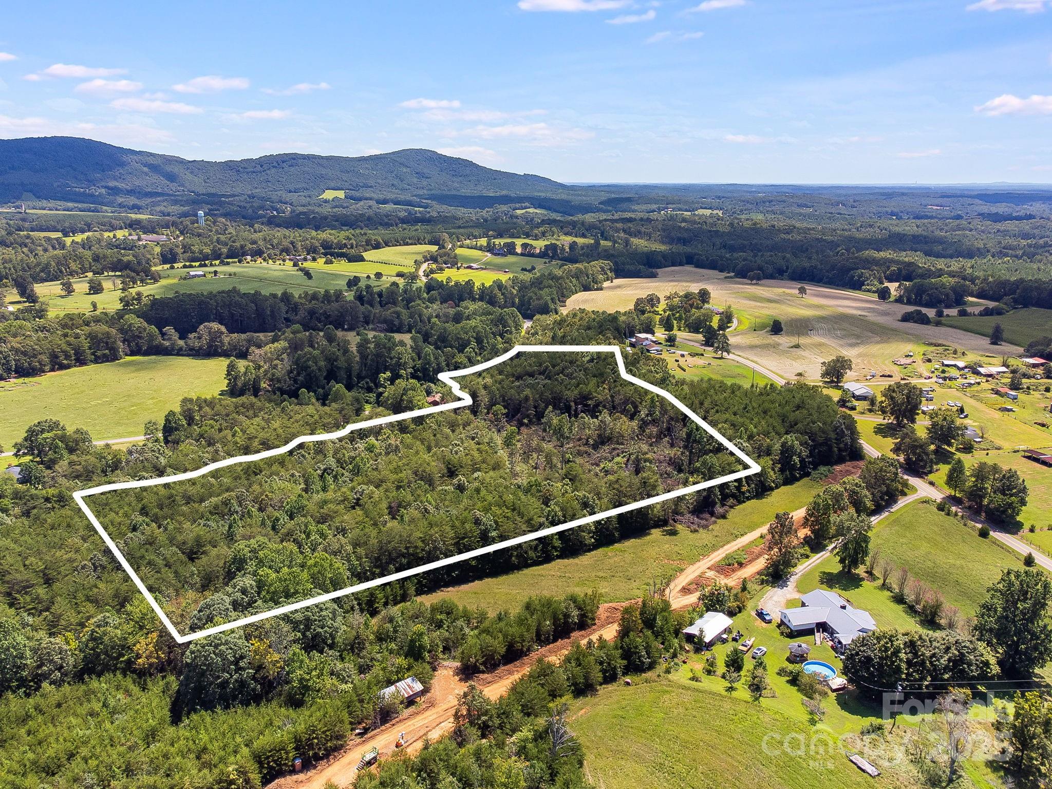 211 Luckadoo Road Bostic, NC 28018 - Photo 24 of 32 a view of a swimming pool with a table and chairs