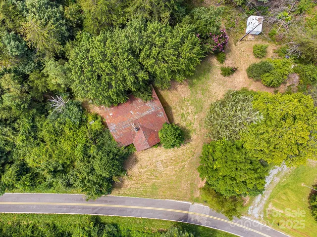 an aerial view of residential houses with yard and swimming pool