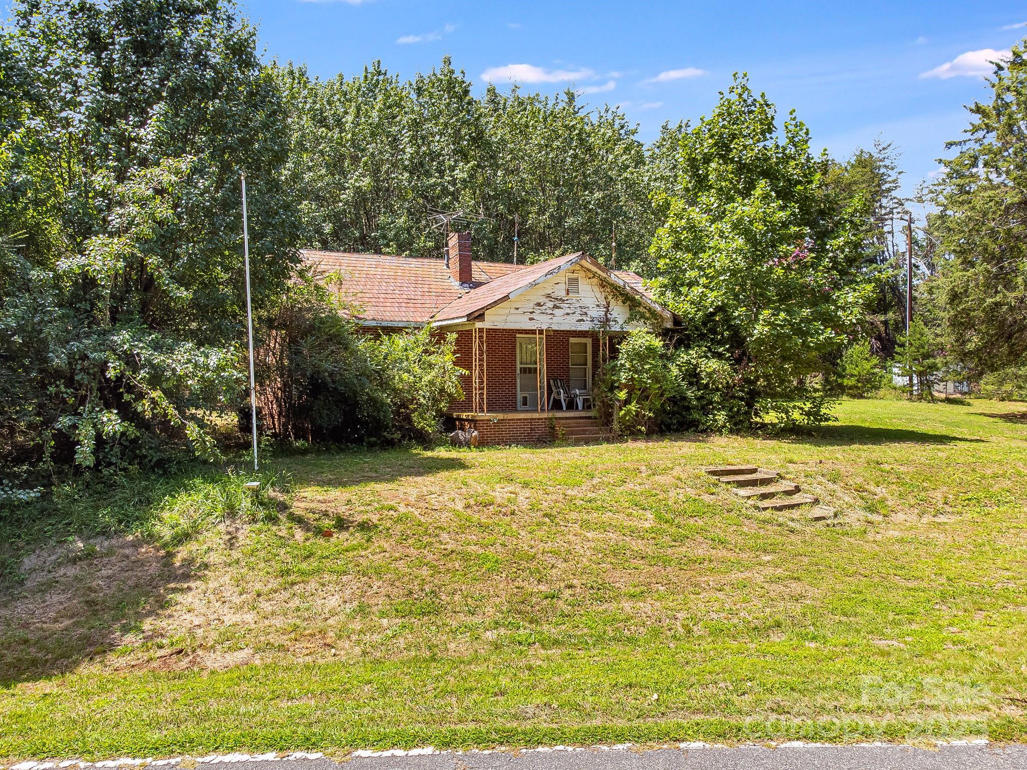 211 Luckadoo Road Bostic, NC 28018 - Photo 8 of 32 a house with swimming pool in front of it